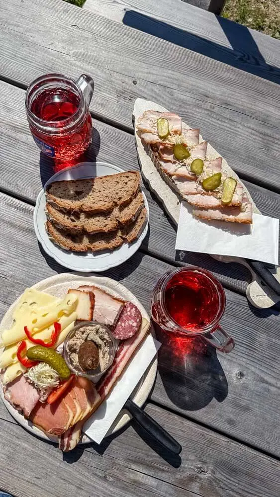 View of meats, cheeses and bread on a table outside