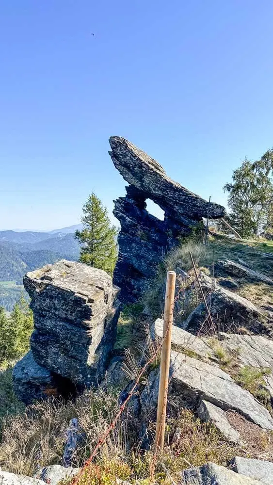 A rock formation with a small window in the Styrian Alps