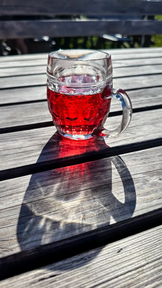 Red colored drink on a table outside