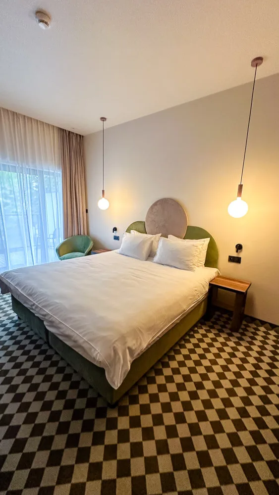 a view of a hotel room with a king-sized bed