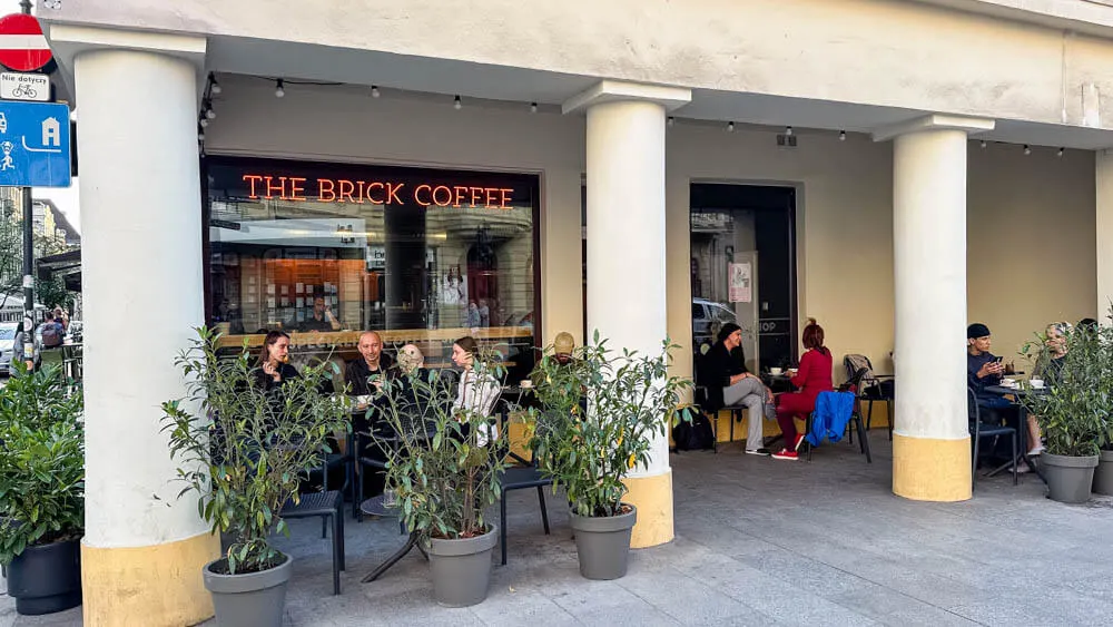 The Brick Coffee Lodz outdoor seating behind pillars