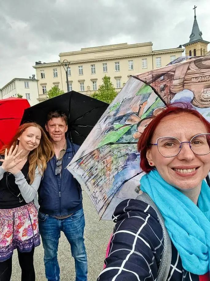 3 people under umbrellas in rainy Poland