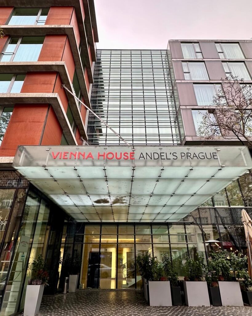 Modern Prague hotel Vienna House Andels Prague with glass facade and covered entrance in the Andel Prague neighborhood.